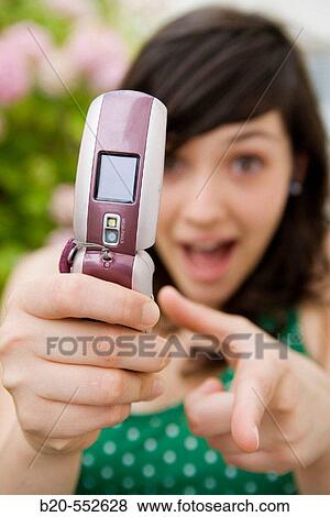 Seventeen year old girl taking pictures with a mobile phone. View Large Photo Image Stock Photo - Seventeen year old girl taking pictures with a mobile phone.. Fotosearch