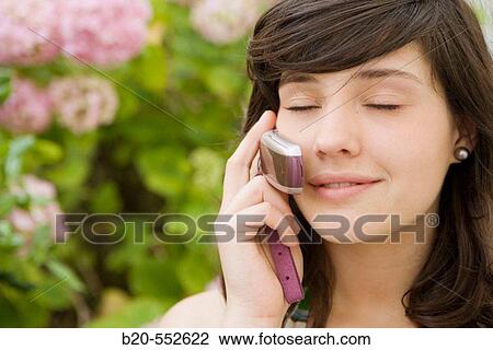 Stock Image - Seventeen year old girl using mobile phone.. Fotosearch