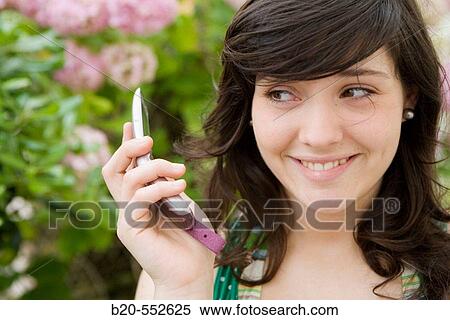 Seventeen year old girl using mobile phone. View Large Photo Image Stock Photography - Seventeen year old girl using mobile phone.. Fotosearch