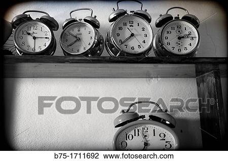Stock Image - several antique clocks on a shelf,. Fotosearch
