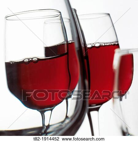 Stock Image - several bowls full of red wine with hints and deformations. Fotosearch