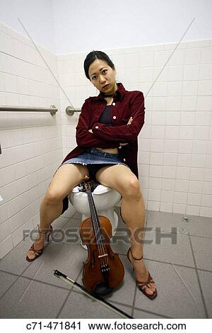 Sexy annoyed asian woman sitting on toilet with violin View Large Photo Image Stock Image - Sexy annoyed asian woman sitting on toilet with violin. Fotosearch