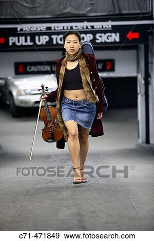 Sexy asian woman walking up parking lot driveway holding violin and violin case View Large Photo Image Stock Photo - Sexy asian woman walking up parking lot driveway holding violin and violin case. Fotosearch
