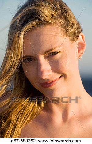 Sexy blond girl with wind blown hair glows in the late day sunshine View Large Photo Image Stock Image - Sexy blond girl with wind blown hair glows in the late day sunshine. Fotosearch