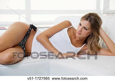 Sexy blonde woman lying down on the couch View Large Photo Image Stock Photography - Sexy blonde woman lying down on the couch. Fotosearch
