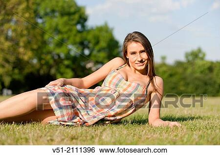 Sexy brunette woman in park smiling at camera View Large Photo Image Stock Photograph - Sexy brunette woman in park smiling at camera. Fotosearch