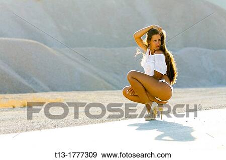 Sexy girl before a sand dune View Large Photo Image Stock Photo - Sexy girl before a sand dune. Fotosearch