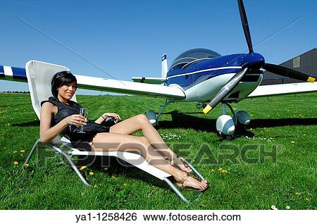 Sexy girl drinking Champagne glassin deckchair by a microlight plane Zenair 601, Belgium View Large Photo Image Stock Photograph - Sexy girl drinking Champagne glassin deckchair by a microlight plane Zenair 601, Belgium. Fotosearch