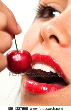 Sexy girl eating a cherry View Large Photo Image Stock Photography - Sexy girl eating a cherry. Fotosearch