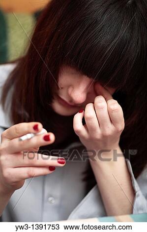 Stock Image - Sexy green eyed brunettewith smoking cigarette. Fotosearch