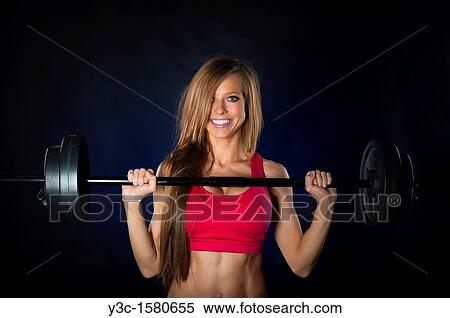Sexy woman working out with weight bar View Large Photo Image Stock Photography - Sexy woman working out with weight bar. Fotosearch