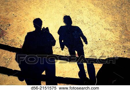 shadow of a couple walking Downteps and taking pictures, Puente del Mar, Valencia, Spain. View Large Photo Image Stock Photography - shadow of a couple walking Downteps and taking pictures, Puente del Mar, Valencia, Spain.. Fotosearch