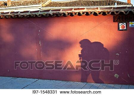 Shadow of a pilgrim on a wall along the Camino de Santiago View Large Photo Image Stock Image - Shadow of a pilgrim on a wall along the Camino de Santiago. Fotosearch