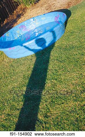 Shadow of child with arms up overhead. Wading pool View Large Photo Image Stock Image - Shadow of child with arms up overhead. Wading pool. Fotosearch