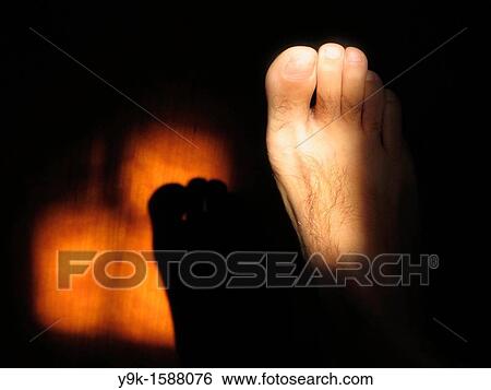 Shadow of foot on wooden door View Large Photo Image Stock Photograph - Shadow of foot on wooden door. Fotosearch
