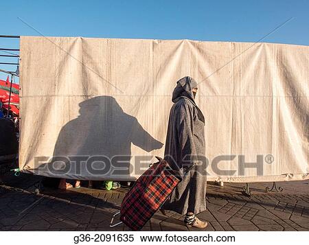 Shadow of people on white canvas hanged to block the sunlight in Djemaa el-Fna square, (the main square) in the Medina in Marrakesch, Morrocco. View Large Photo Image Stock Photography - Shadow of people on white canvas hanged to block the sunlight in Djemaa el-Fna square, (the main square) in the Medina in Marrakesch, Morrocco.. Fotosearch