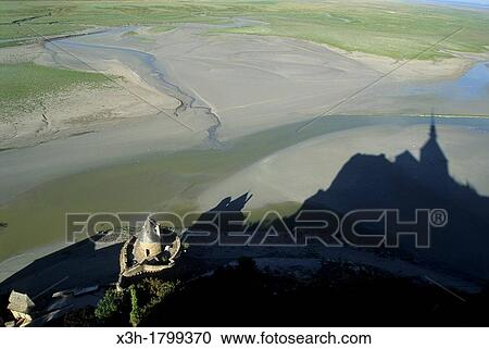 shadow of the monastery on the shore at low tide, Mont-Saint-Michel bay, Manche department, Normandy region, France, Europe View Large Photo Image Stock Image - shadow of the monastery on the shore at low tide, Mont-Saint-Michel bay, Manche department, Normandy region, France, Europe. Fotosearch