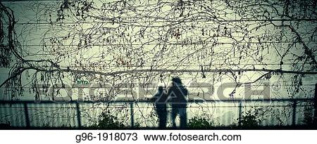 Shadow of two people at the wall View Large Photo Image Stock Image - Shadow of two people at the wall. Fotosearch