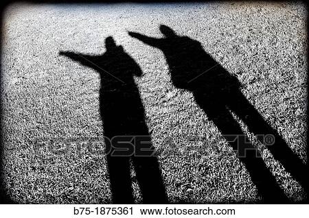 shadow of two people pointing to his left View Large Photo Image Stock Image - shadow of two people pointing to his left. Fotosearch