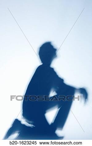 Shadow, young boy crouched, looking ahead View Large Photo Image Stock Photography - Shadow, young boy crouched, looking ahead. Fotosearch