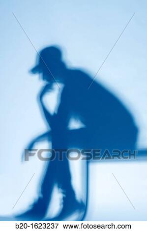 Shadow, young man sitting View Large Photo Image Stock Photo - Shadow, young man sitting. Fotosearch