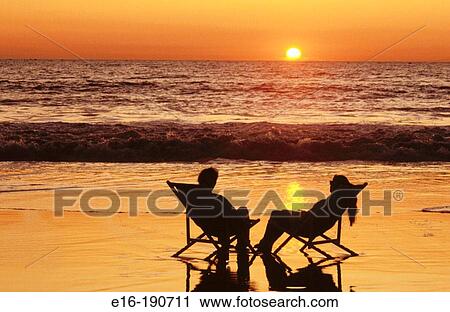 Sharing beach sunset View Large Photo Image Stock Image - Sharing beach sunset. Fotosearch