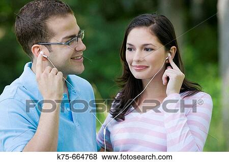 Sharing mp 3 player View Large Photo Image Stock Photo - Sharing mp 3 player. Fotosearch