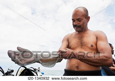 Shark feeder prepares itself with Chain Gloves, Beqa Lagoon, Viti Levu, Fiji View Large Photo Image Stock Image - Shark feeder prepares itself with Chain Gloves, Beqa Lagoon, Viti Levu, Fiji. Fotosearch
