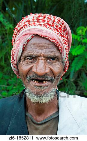 Stock Image - Shashemene Ethiopia Africa Alaba tribe portrait of local old man with red turban farmer and smile 9. Fotosearch