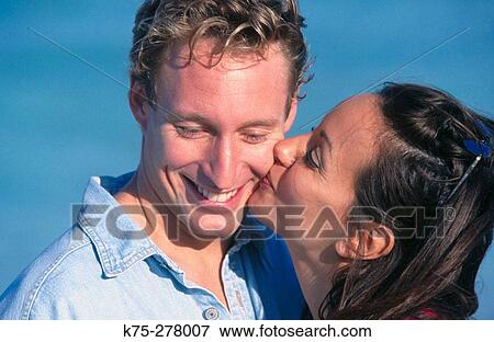 she gives him a big kiss View Large Photo Image Stock Photo - she gives him a big kiss. Fotosearch