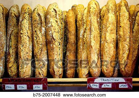 Shelf of a bakery with many traditional baguettes in Paris, France, Europe View Large Photo Image Stock Photo - Shelf of a bakery with many traditional baguettes in Paris, France, Europe. Fotosearch