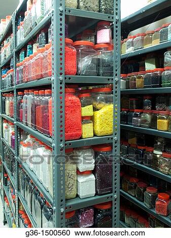 Shelves of jars of beads, sequins and various embellishments in the Mumbai, India workshop/office of an Indian company that makes embroidery for the fashion industry, which is sold around the world View Large Photo Image Stock Image - Shelves of jars of beads, sequins and various embellishments in the Mumbai, India workshop/office of an Indian company that makes embroidery for the fashion industry, which is sold around the world. Fotosearch