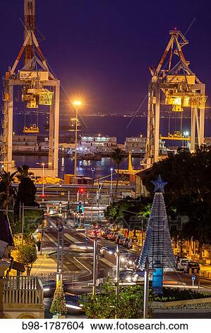 Shipping container cranes illuminated at night in Haifa's port View Large Photo Image Picture - Shipping container cranes illuminated at night in Haifa's port. Fotosearch
