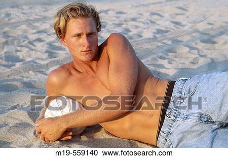 shirtless man lying on the beach View Large Photo Image Stock Image - shirtless man lying on the beach. Fotosearch