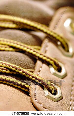 Stock Photography - Shoelaces and eyelets of boot, close up. England, UK. Fotosearch