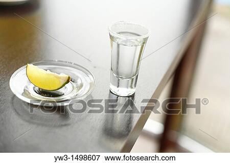 Shooter glass with tequila lime and salt View Large Photo Image Stock Photo - Shooter glass with tequila lime and salt. Fotosearch