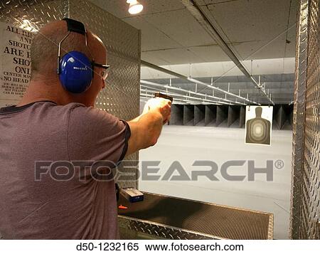 Stock Photography - Shooting range Target and a Glock pistol, Torrington, Connecticut, USA. Fotosearch