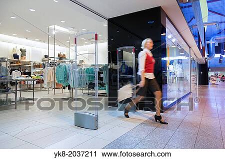 Shop entrance or exit. Woman buyer passed retail shop security gate. Person in the move. Shopping. View Large Photo Image Stock Image - Shop entrance or exit. Woman buyer passed retail shop security gate. Person in the move. Shopping.. Fotosearch