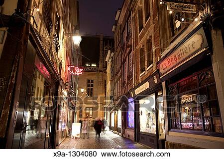 Shop fronts illuminated at night in Thouret street, Rouen, Normandy, France. View Large Photo Image Stock Image - Shop fronts illuminated at night in Thouret street, Rouen, Normandy, France.. Fotosearch