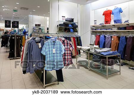 Shop interior with mannequin, dummy. Shelf, rack and clothes hanging in retail store. View Large Photo Image Stock Photo - Shop interior with mannequin, dummy. Shelf, rack and clothes hanging in retail store.. Fotosearch