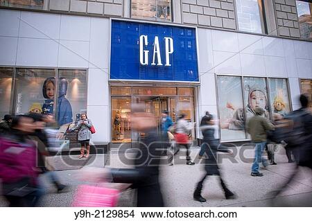 Shoppers outside a Gap store in the Herald Square shopping district in New York View Large Photo Image Picture - Shoppers outside a Gap store in the Herald Square shopping district in New York. Fotosearch