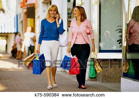 Shopping and talking View Large Photo Image Picture - Shopping and talking. Fotosearch