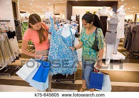 Shopping for a new dress View Large Photo Image Stock Photography - Shopping for a new dress. Fotosearch