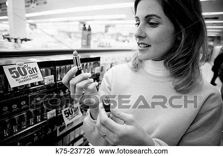 Stock Photograph - Shopping for lipstick. Fotosearch