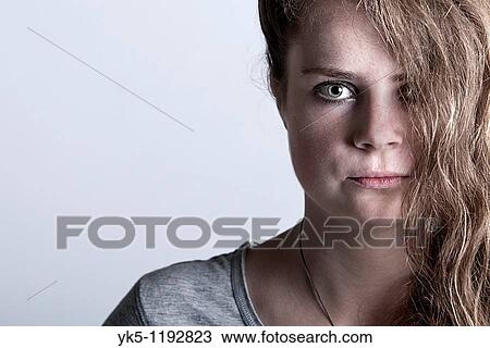 Shot of a Young Woman with her Hair Covering Half of her Face View Large Photo Image Stock Image - Shot of a Young Woman with her Hair Covering Half of her Face. Fotosearch
