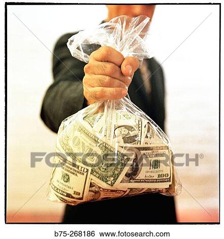 Showing a plastic bag full of dollars View Large Photo Image Stock Photograph - Showing a plastic bag full of dollars. Fotosearch