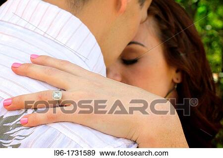 Stock Photo - showing off engagement ring in a quiet moment. Fotosearch