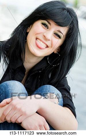 Stock Image - Showing tongue as a friendly provocation. Fotosearch