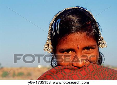 Shy tribal girl laughing. Rajasthan, India. She belongs to the Bhil community. View Large Photo Image Stock Photo - Shy tribal girl laughing. Rajasthan, India. She belongs to the Bhil community.. Fotosearch