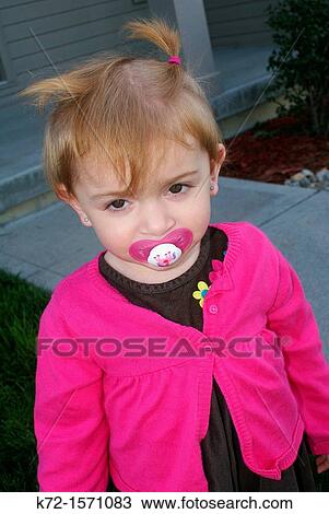 Shy young girl with a pacifier View Large Photo Image Stock Image - Shy young girl with a pacifier. Fotosearch